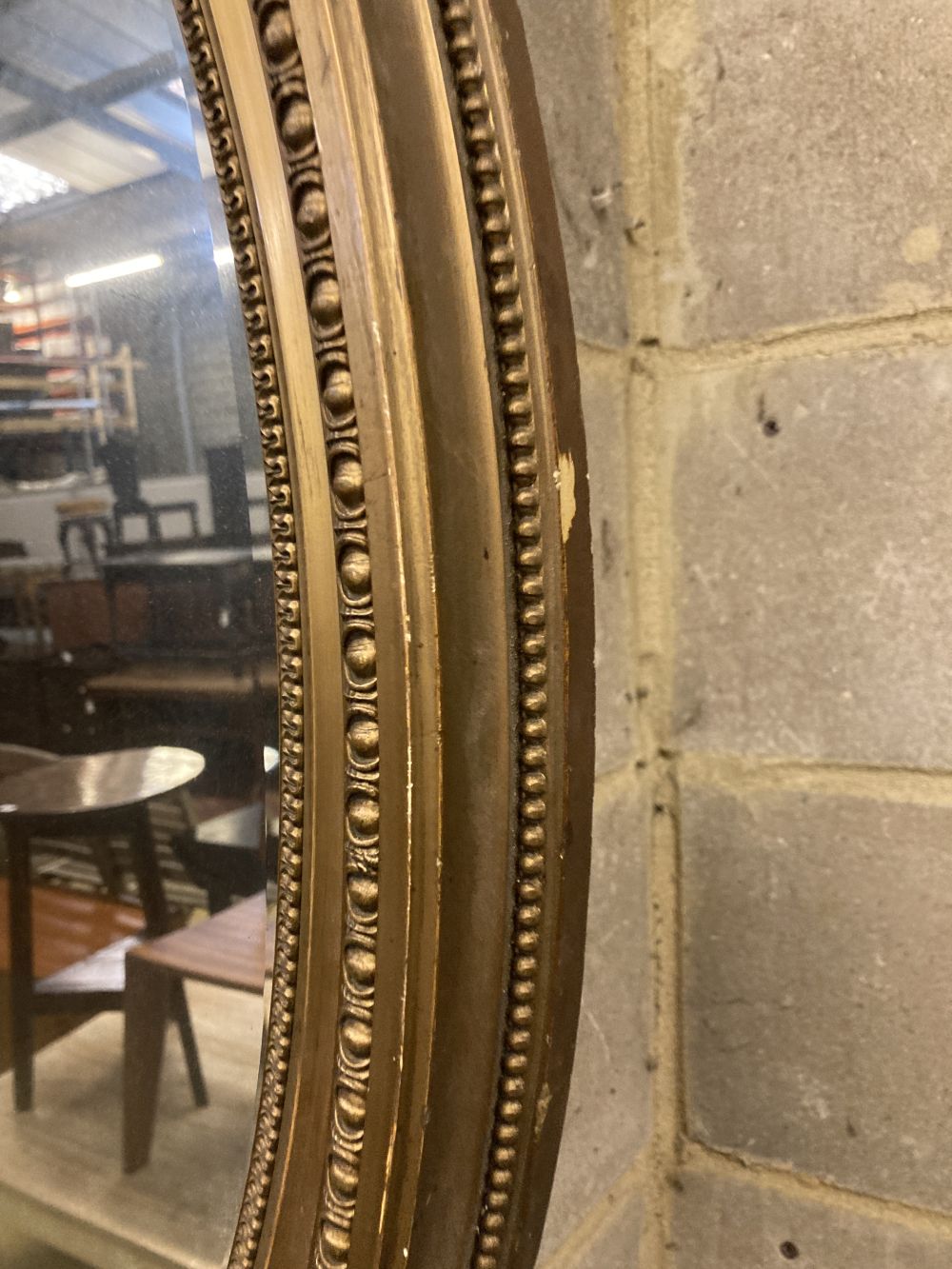An oval gilt framed wall mirror, width 62cm, height 87cm